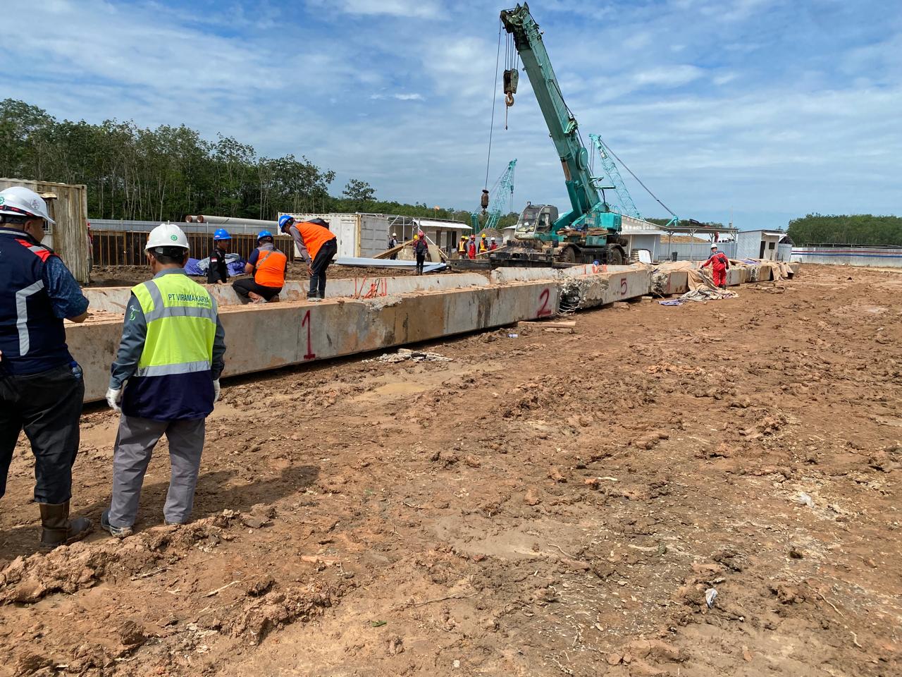 Construction site with crane and structural concrete works